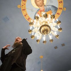 With a mural of Jesus Christ overhead, the Rev. Justin Havens speaks to an interfaith guided tour during their third and final stop at St. Peter and Paul Orthodox Church Feb. 24, 2016, in Salt Lake City. The tour, sponsored by the Salt Lake Interfaith Roundtable, allows patrons from all religious backgrounds to experience and educate themselves about other faiths during Interfaith Month.