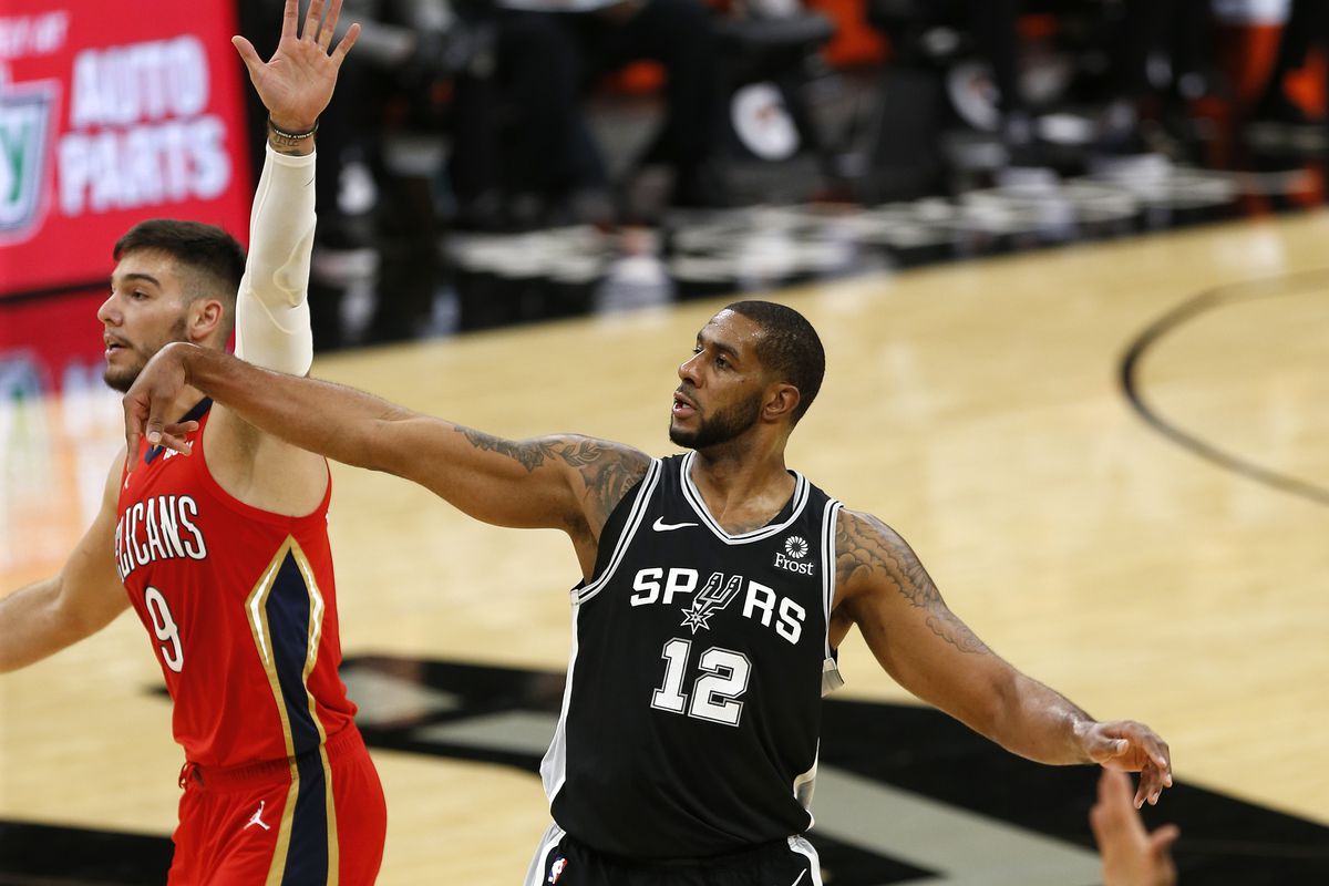 LaMarcus Aldridge of the San Antonio Spurs watches his three as does Willy Hernangomez of the New Orleans Pelicans in the first half at AT&amp;T Center on February 27, 2021 in San Antonio, Texas.
