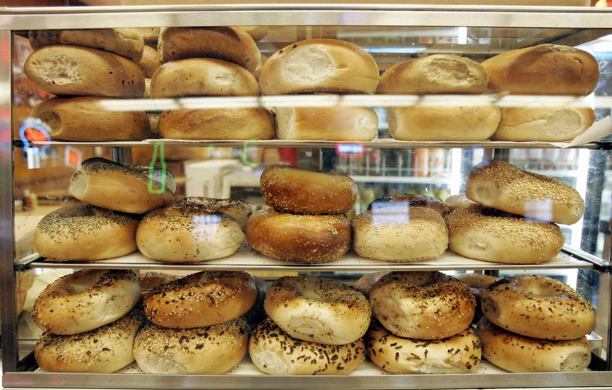 A display case filled with bagels