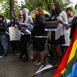 Annie Renteria, right, holds a rainbow flag in remembrance of the victims of the Pulse nightclub shooting in Orlando, Florida, at the Salt Lake City-County Building in Salt Lake City on Monday, June 13, 2016.