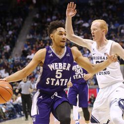 Weber State Wildcats guard Cody John (5) tries to drive around Brigham Young Cougars guard TJ Haws (30) as BYU and Weber State play at the Marriott Center in Provo on Wednesday, Dec. 7, 2016.