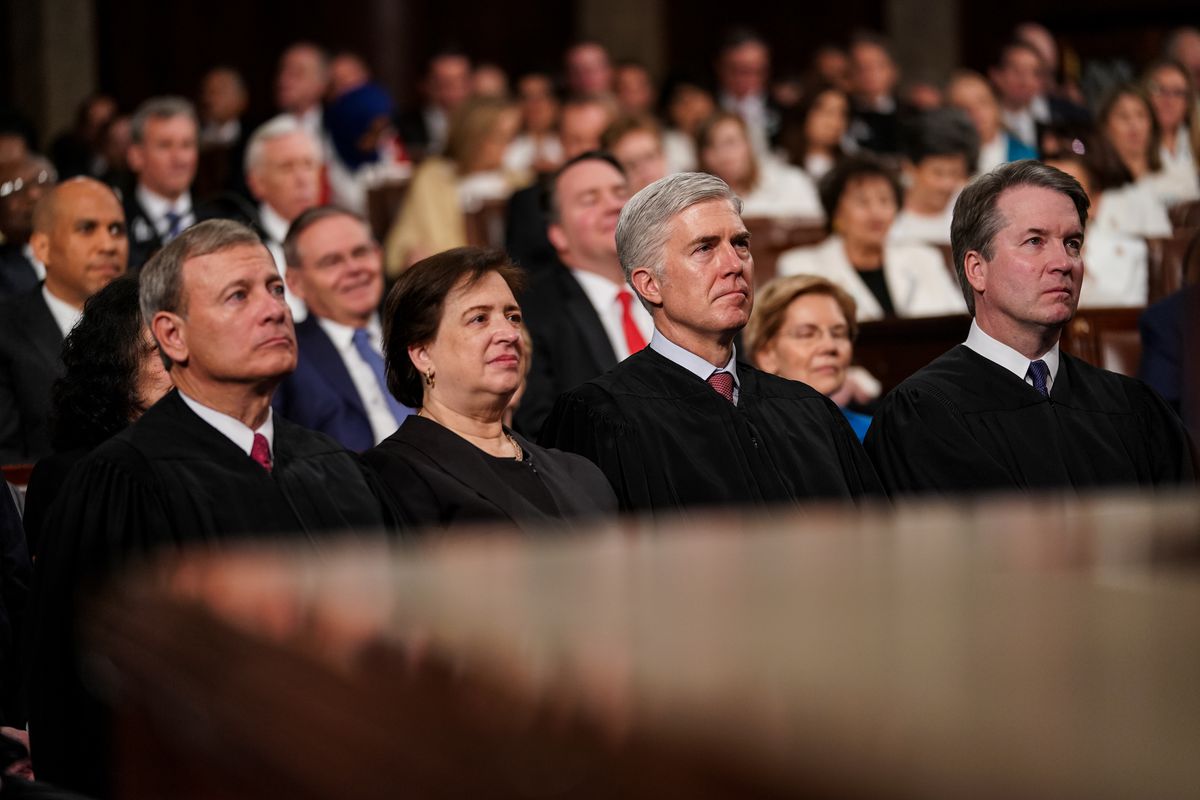 The judges sit, wearing their robes.