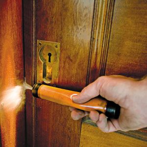<p>A smoke stick demonstrates how air leaks through a vulnerable door</p>