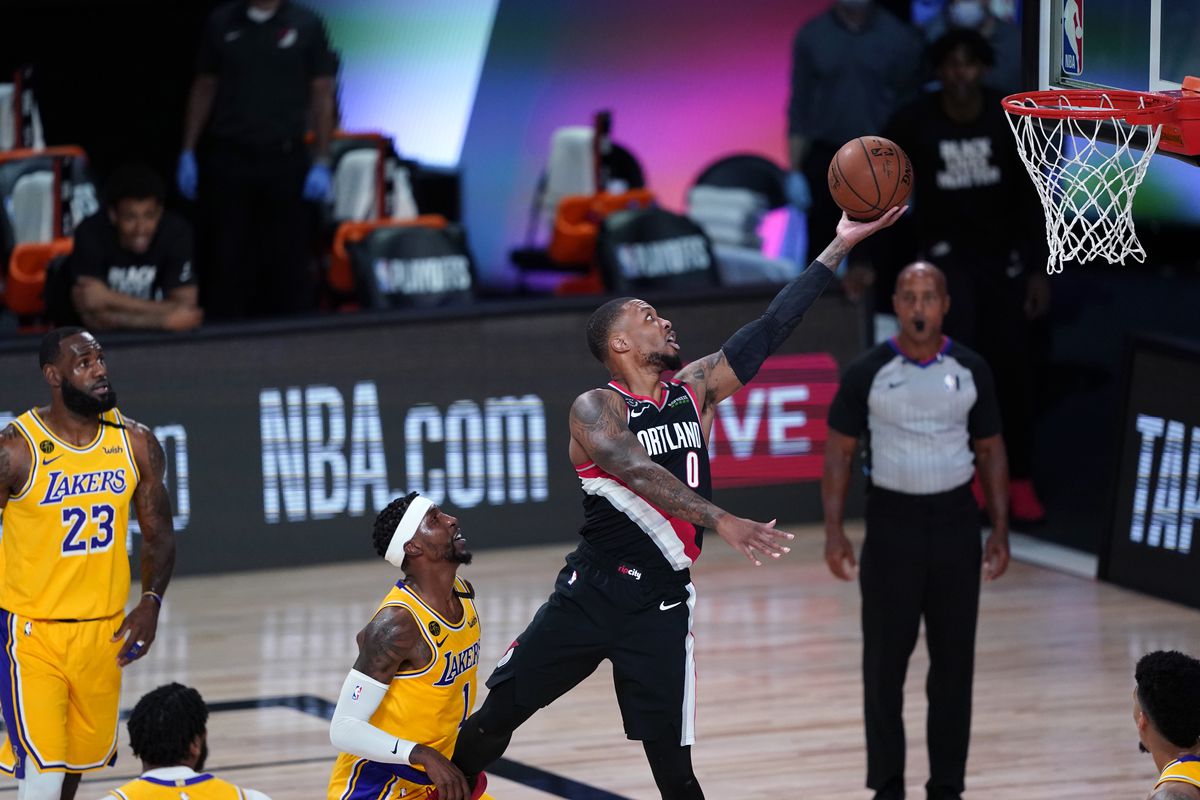 Damian Lillard of the Portland Trail Blazers goes to the basket over Kentavious Caldwell-Pope of the Los Angeles Lakers during the first half in Game 1 of Round 1 of the NBA Playoffs at AdventHealth Arena at ESPN Wide World Of Sports Complex on August 18, 2020 in Lake Buena Vista, Florida.&nbsp;