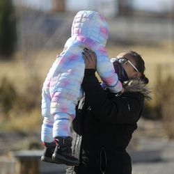 Jessica Green lifts up son Atticus Jackson in a park outside of the Overstock.com headquarters, which is within walking distance from the Road Home’s Midvale Family Shelter where they’ve been staying, in Midvale on Wednesday, Dec. 2, 2020.