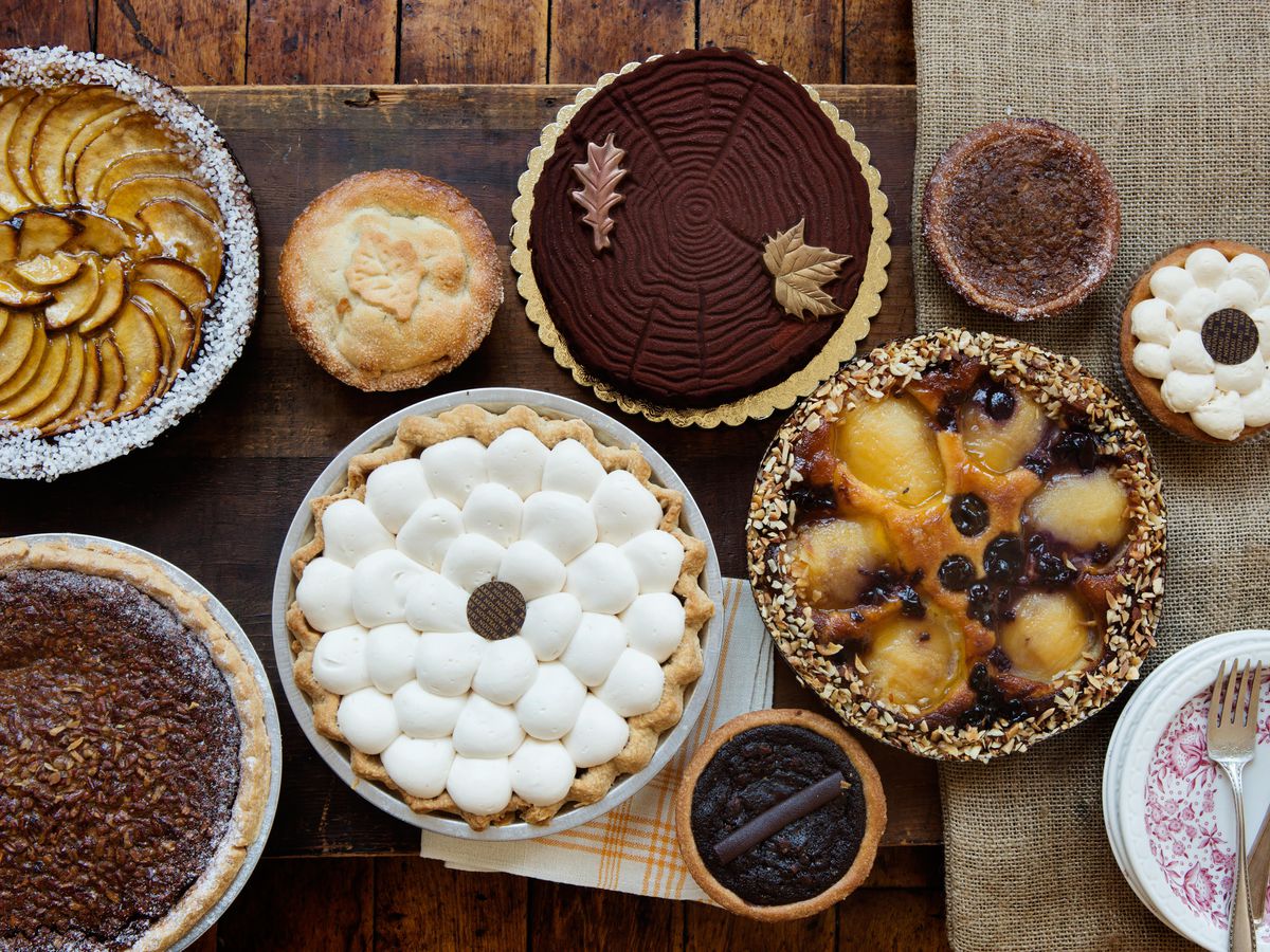 Bird’s eye view of a variety of pies, from apple to the far left to a marshmellow-topped pumpkin one in the middle.