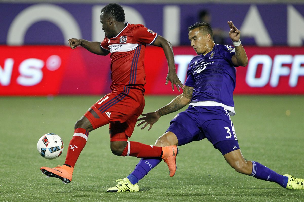 David Accam (left) beats defender Seb Hines to a loose ball before scoring in an early season game against Orlando City. 