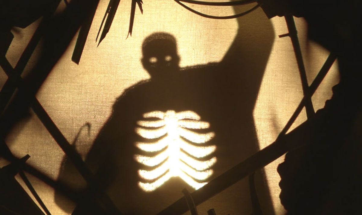 A shadow puppet of a hook-handed man with his ribcage exposed and empty in the 2021 Candyman