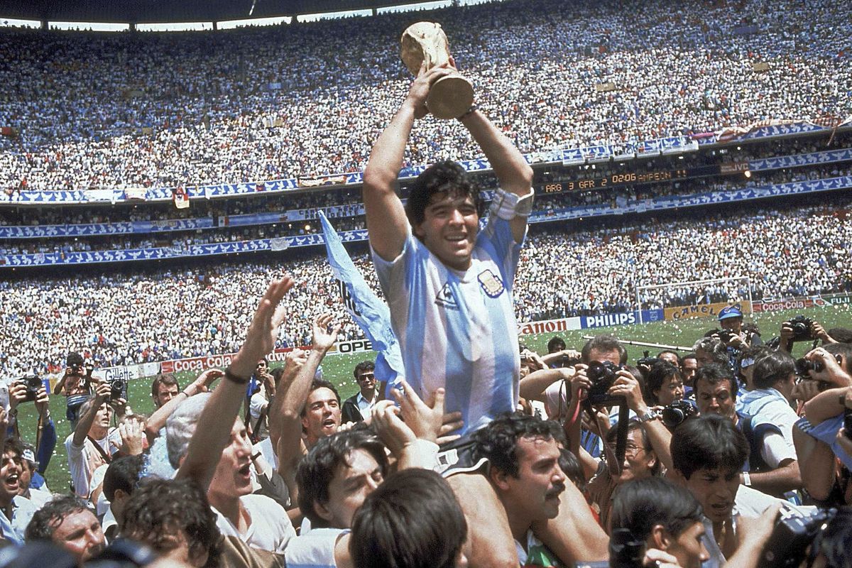 Diego Maradona holds up the World Cup after Argentina’s 3-2 victory over West Germany at the 1986 final. The Argentine soccer great who was among the best players ever has died. He was 60.