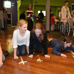 Girls shoot marshmallows from catapults during an interactive "Just for Girls" event at Zaniac, an after-school program that offers enrichment classes in science, technology, engineering and math, in Salt Lake City on Thursday, Dec. 4, 2014.