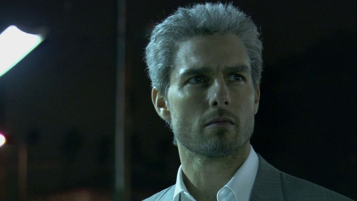 Tom Cruise looks dramatically off in the distance in a nighttime shot from Collateral.