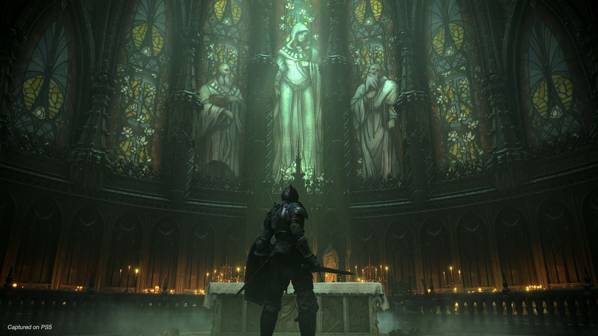 A knight stands before a church altar and stained glass windows in a screenshot from Demon’s Souls