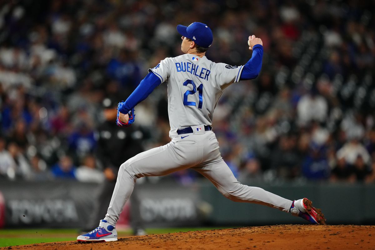 Los Angeles Dodgers starting pitcher Walker Buehler (21) delivers against the Colorado Rockies in the fourth inning at Coors Field.