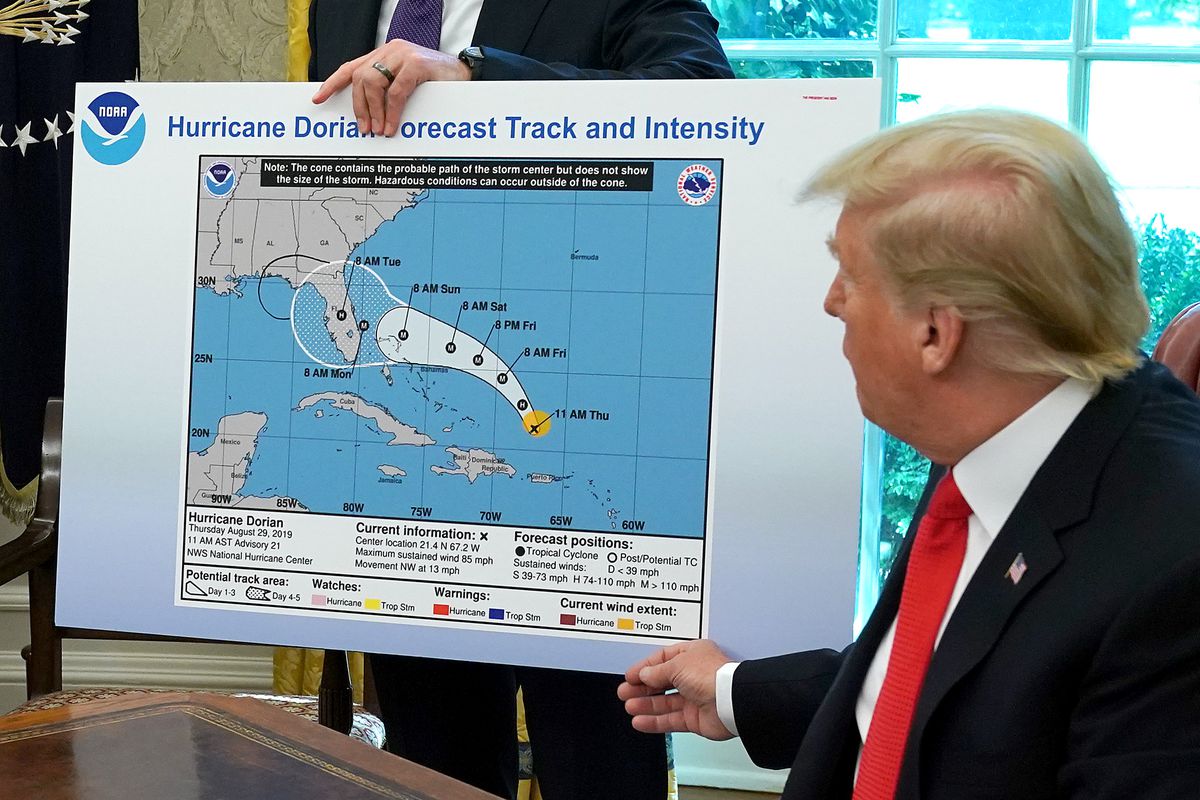 U.S. President Donald Trump references a map held by acting Homeland Security Secretary Kevin McAleenan while talking to reporters following a briefing from officials about Hurricane Dorian in the Oval Office at the White House on September 4, 2019, in Washington, DC.