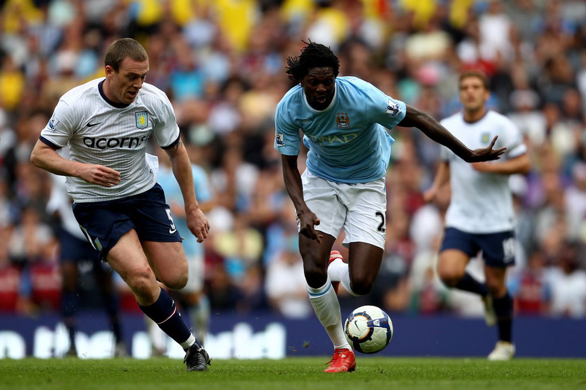 Emmanuel Adebayor seeks to evade the challenge of Richard Dunne during yesterday's clash at Eastlands. (Picture from Getty images)