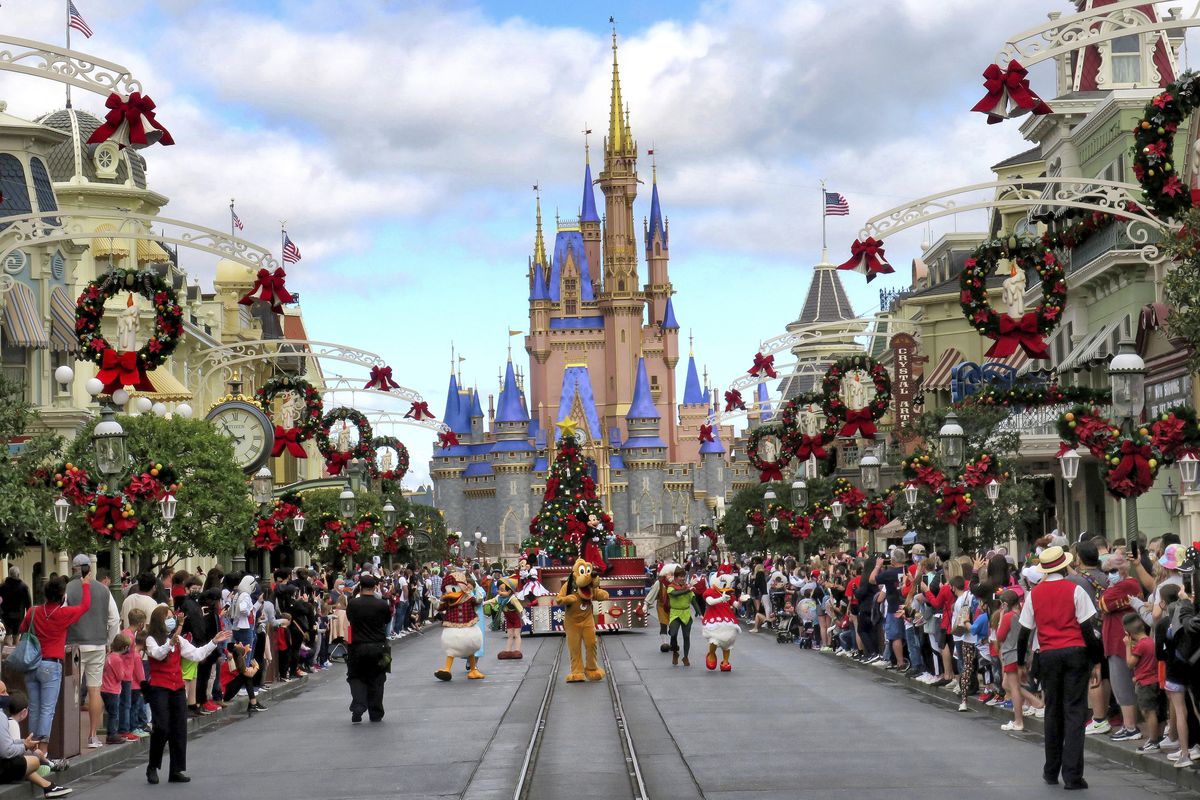 Crowds line Main Street USA, with Cinderella Castle on the horizon, at the Magic Kingdom at Walt Disney World, in Lake Buena Vista, Fla., Monday, Dec. 21, 2020. Disney’s Florida parks are currently operating at 35% capacity due to the Covid-19 pandemic.