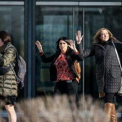 Shoppers evacuate with their hands in the air after a shooting at Fashion Place Mall in Murray on Sunday, Jan. 13, 2019.