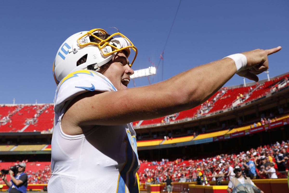 Justin Herbert #10 of the Los Angeles Chargers celebrates after defeating the Kansas City Chiefs 30-24 at Arrowhead Stadium on September 26, 2021 in Kansas City, Missouri.