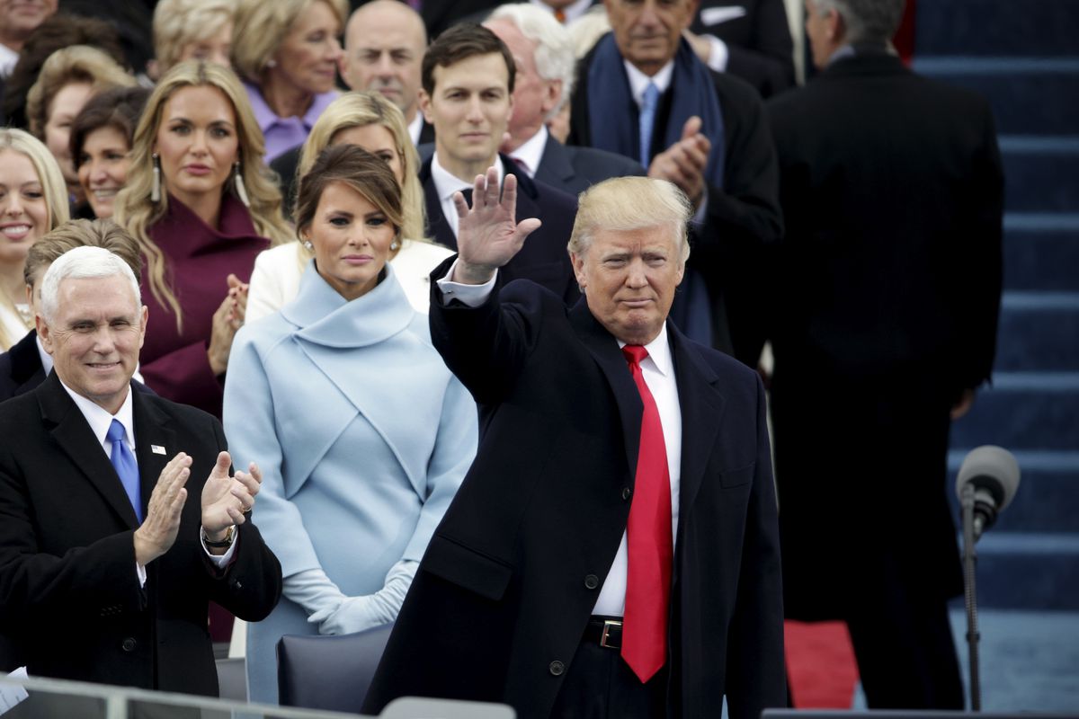 President Elect Donald Trump waves to spectators as Vice President Elect Mike Pence and Melania Trump look on at the West Front of the U.S. Capitol on January 20, 2017 in Washington, DC. In today's inauguration ceremony Donald J. Trump becomes the 45th Pr