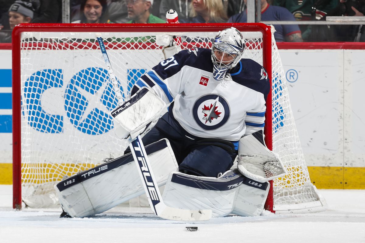 Connor Hellebuyck of the Winnipeg Jets makes a save in the third period of the game against the Minnesota Wild at Xcel Energy Center on April 11, 2023 in St. Paul, Minnesota.
