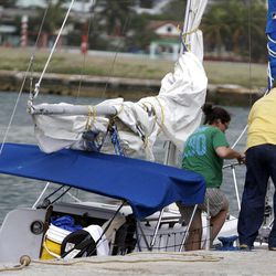 Sharyn Hakken is helped out of her boat by a safety officer at the Hemingway Marina in Havana on Tuesday.