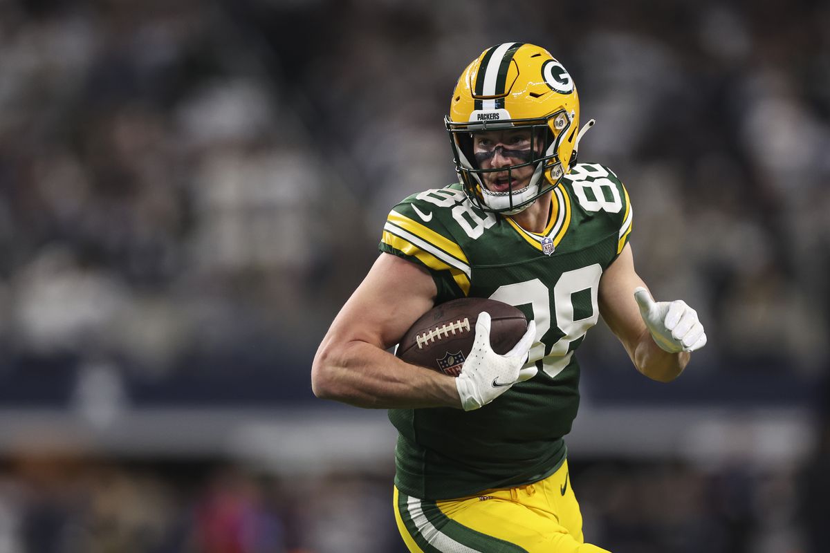 Luke Musgrave #88 of the Green Bay Packers runs the ball during an NFL wild-card playoff football game against the Dallas Cowboys at AT&amp;T Stadium on January 14, 2024 in Arlington, Texas.