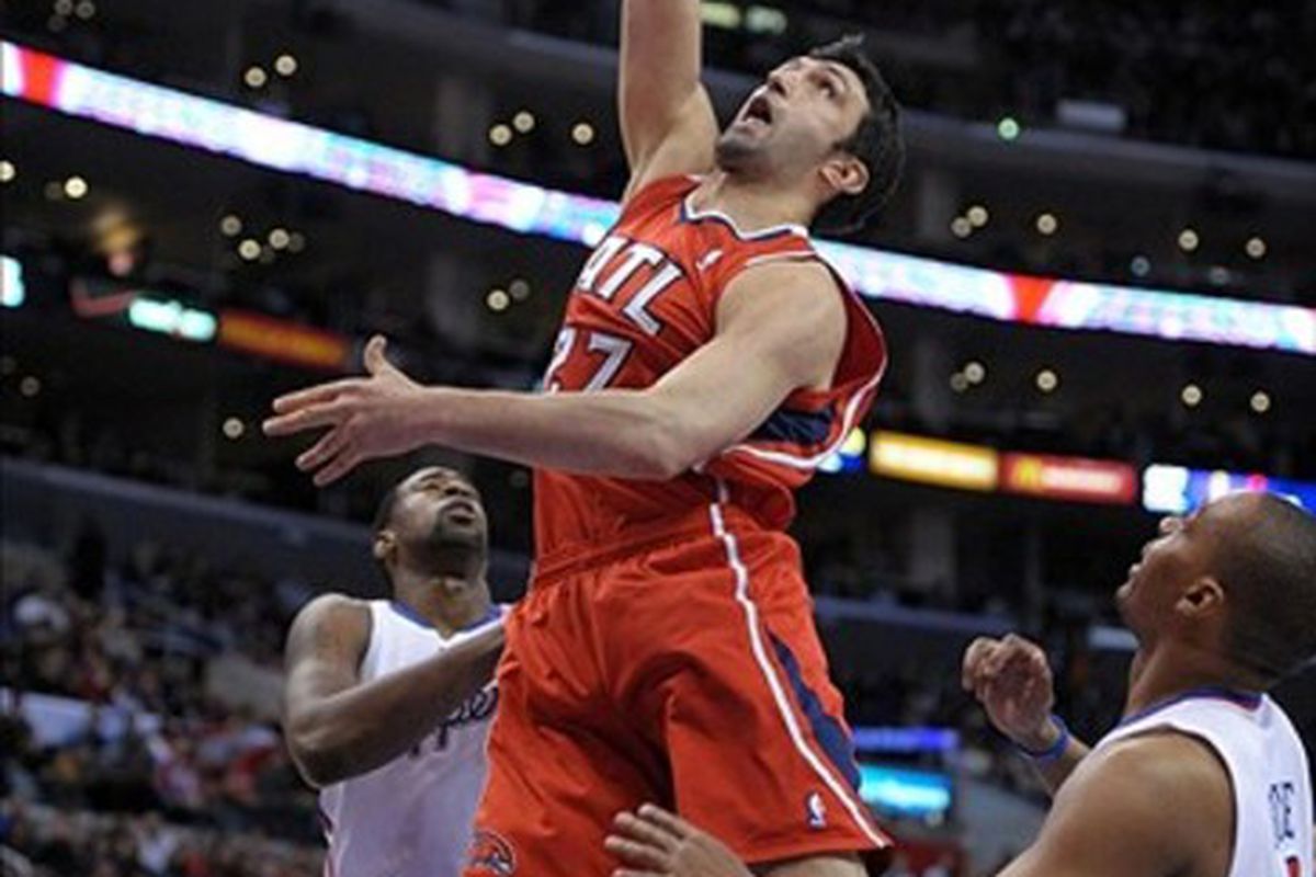 Mar 14, 2012, Los Angeles, CA, USA; Atlanta Hawks center Zaza Pachulia (27) is defended by Los Angeles Clippers center DeAndre Jordan (1) and guard Randy Foye (4) at the Staples Center. Mandatory Credit: Kirby Lee/Image of Sport-US PRESSWIRE
