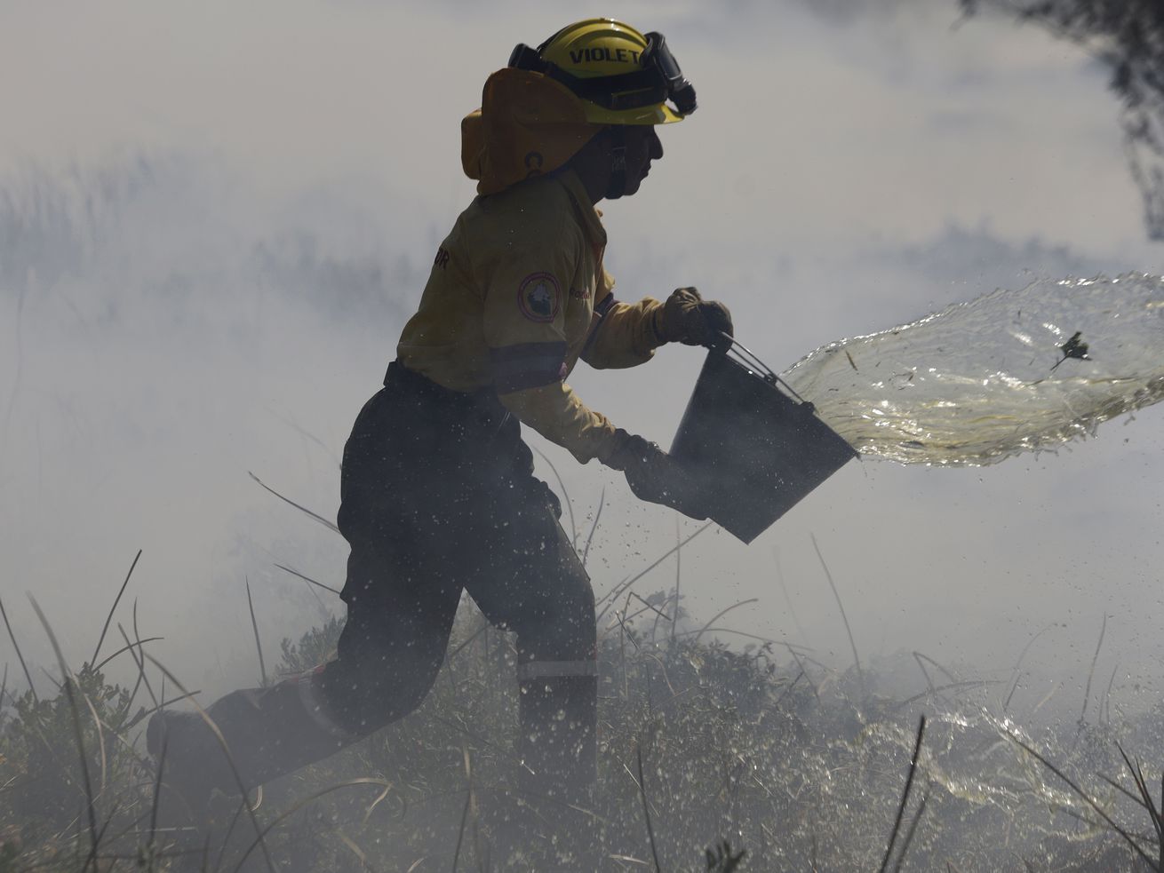 A firefighter is trying to put out a fire in the Cuemanco Ecological Park in Xochimilco, Mexico City.