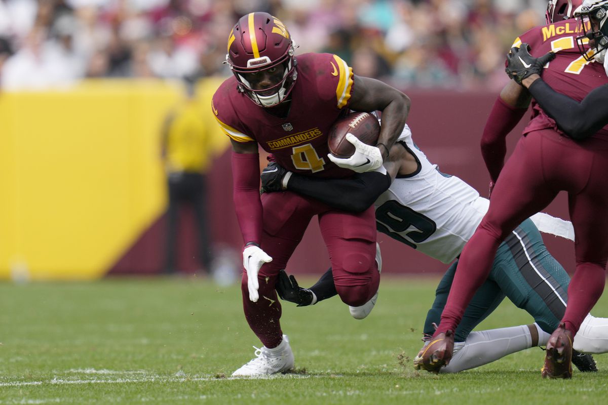 Curtis Samuel #4 of the Washington Commanders runs with the ball as Eli Ricks #39 of the Philadelphia Eagles tackles during the first quarter at FedExField on October 29, 2023 in Landover, Maryland.