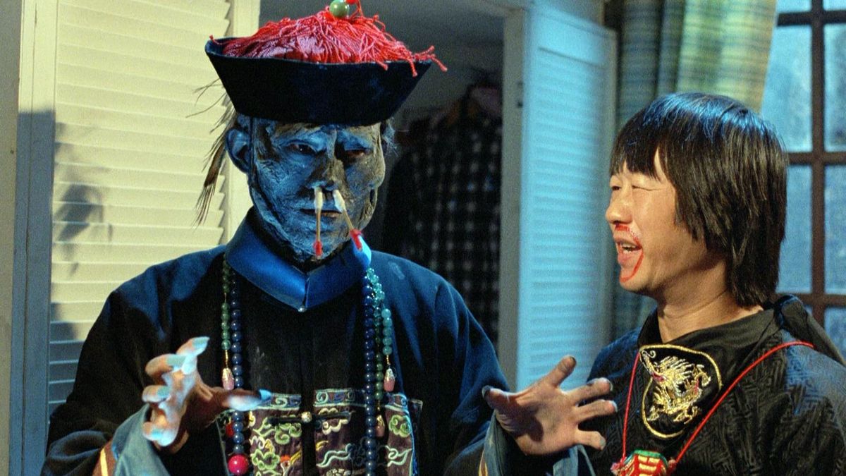 A vampire hunter laughs at a jiangshi after sticking cotton swaps up its nose