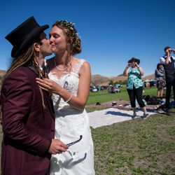 Liam Dorney, of Brisbane, Australia, left, and Elien Wijns, of Brussels, Belgium, kiss after viewing the total solar eclipse at Mann Creek Reservoir near Weiser, Idaho, on their wedding day, Monday, Aug. 21, 2017. The couple met while viewing a total solar eclipse in Australia, got engaged while viewing another total solar eclipse in the Faroe Islands and have since seen another in Indonesia. The couple wed later Monday after viewing this latest total solar eclipse with family and friends.