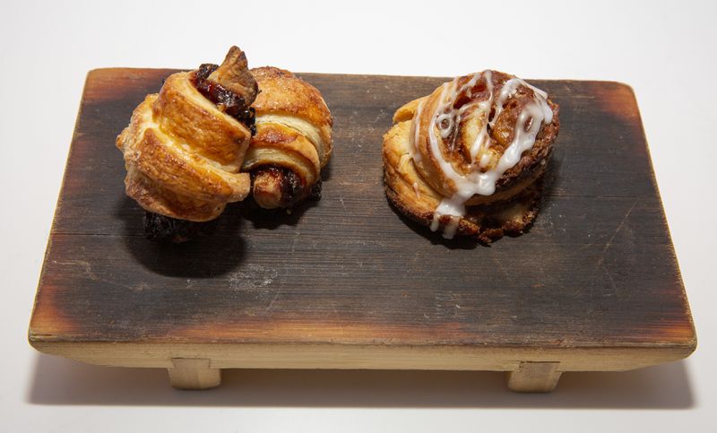 Rolled sweet pastries on a wooden plate