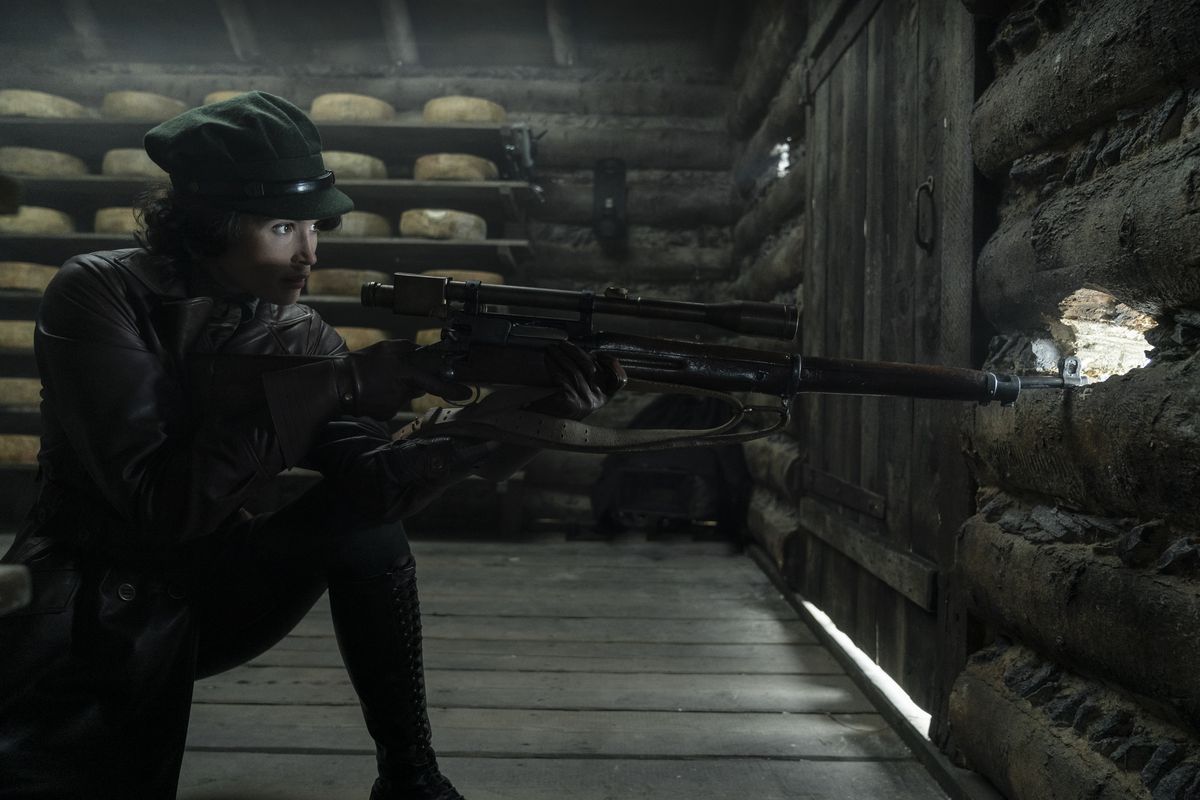 Gemma Arterton aims a sniper rifle in The King's Man
