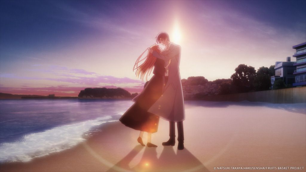 Katsuya and Kyoko on the beach, with a setting sun behind them 