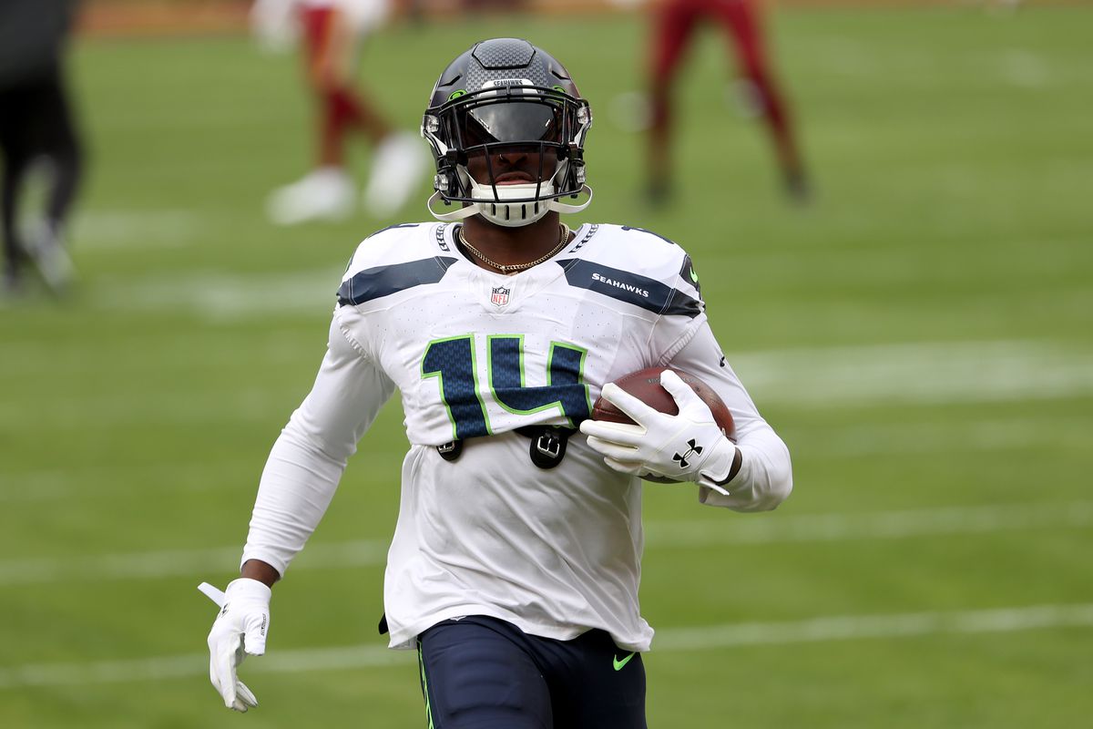 Wide receiver DK Metcalf #14 of the Seattle Seahawks warms up before the start of their game against the Washington Football Team at FedExField on December 20, 2020 in Landover, Maryland.