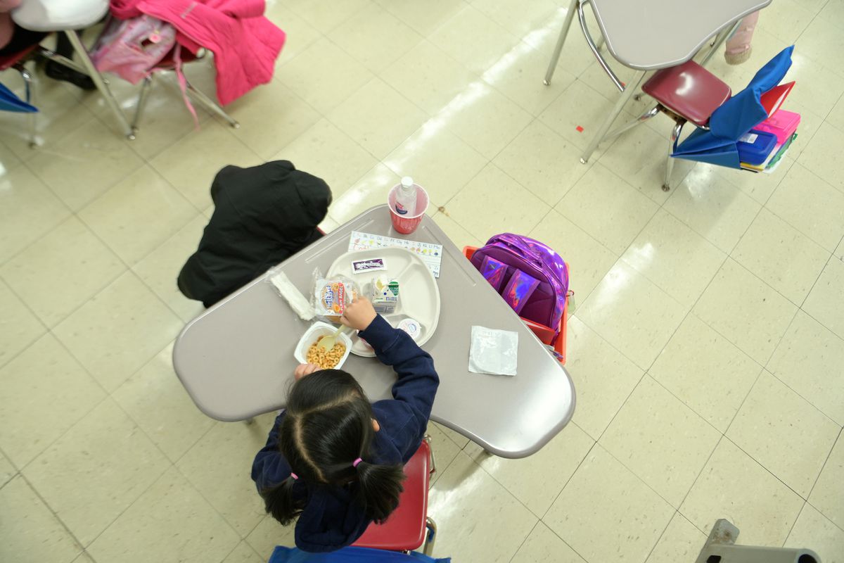 NEW YORK, NEW YORK - JANUARY 13: A kindergarten student eating breakfast at Yung Wing School P.S. 124 on January 13, 2021 in New York City. New York City Public Schools continue to adapt learning environments during the COVID-19 pandemic. The nation’s largest school district continues to face uncertainty with COVID-19 cases on the rise city, state and nationwide. (Photo by Michael Loccisano/Getty Images)