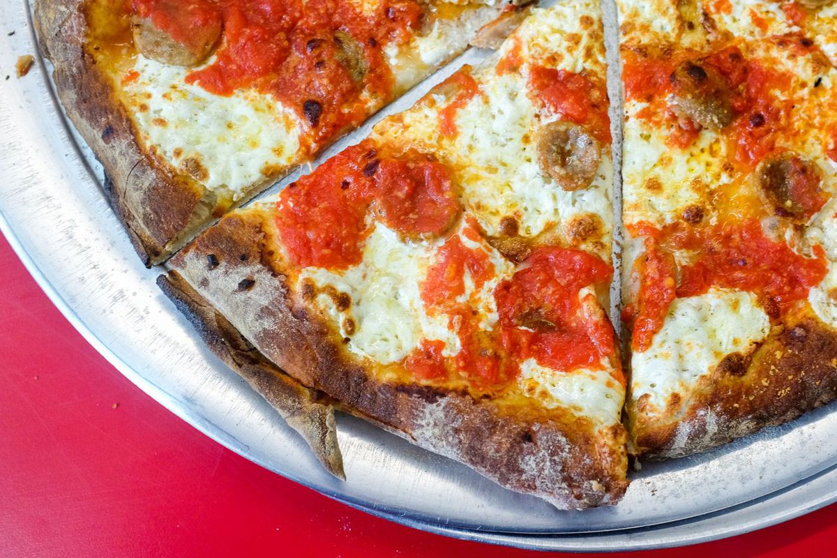 Three slices of Totonno’s pizza, which has splotches of white mozzarella.