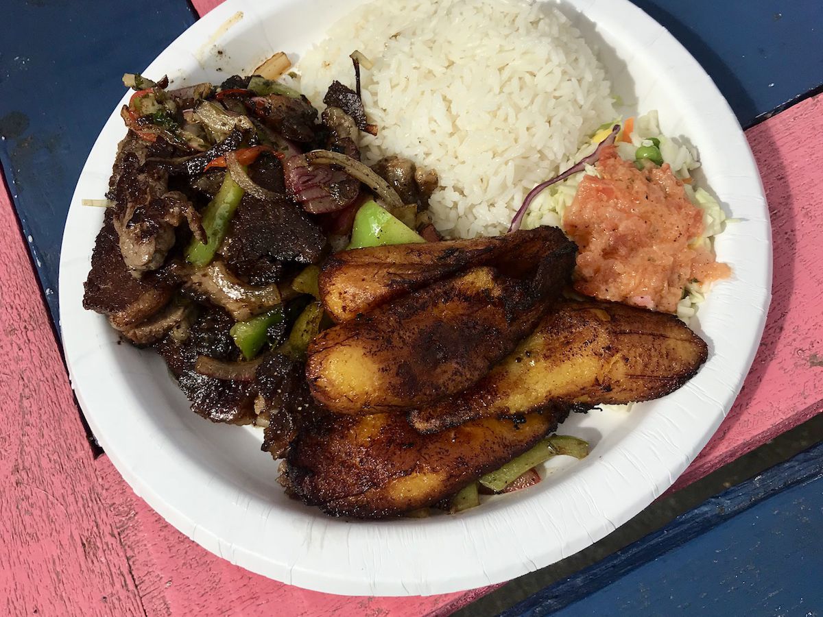 plate of meat, plantains, and rice.