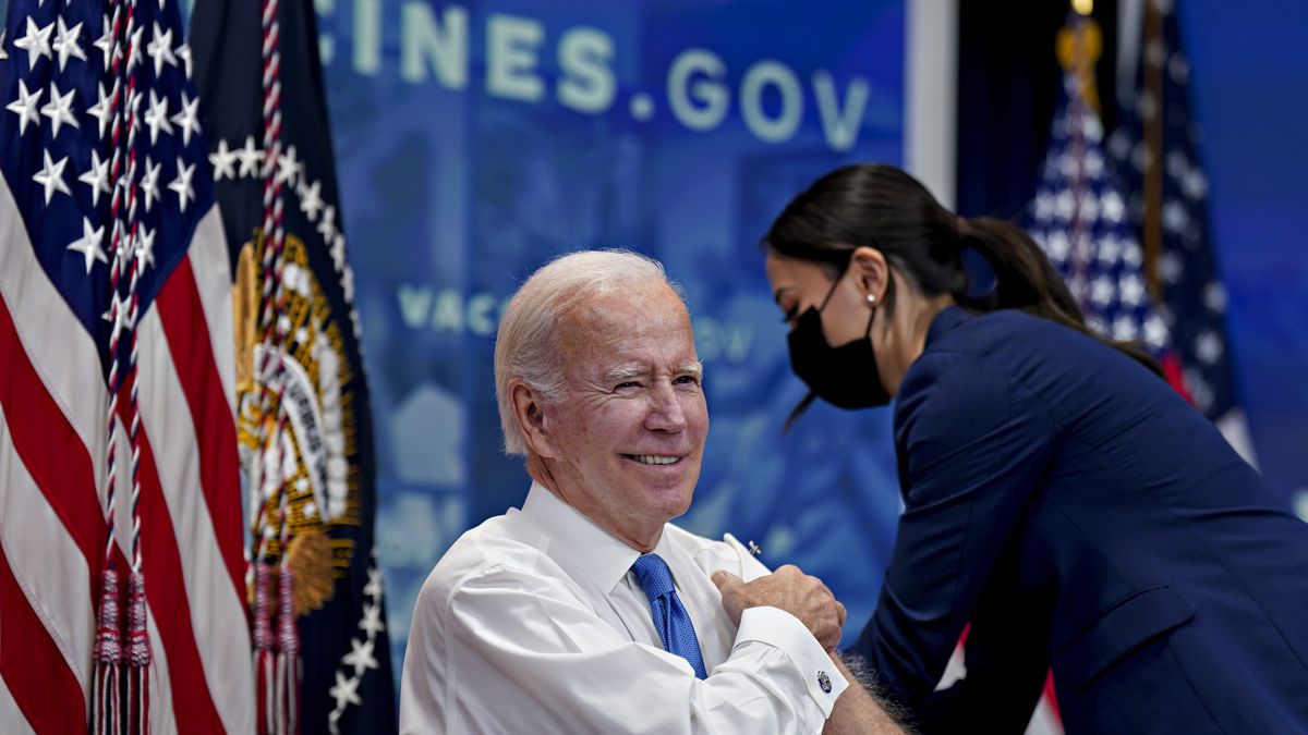 US President Joe Biden smiles before receiving a booster dose of the Covid-19 vaccine targeting the omicron BA.4/BA.5 subvariants in the Eisenhower Executive Office Building in Washington, DC, on October 25, 2022.