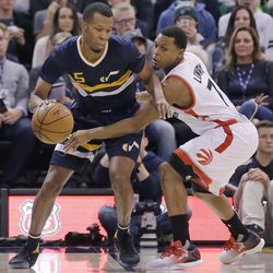 Toronto Raptors guard Kyle Lowry (7) guards Utah Jazz guard Rodney Hood (5) in the first half during an NBA basketball game Friday, Dec. 23, 2016, in Salt Lake City. 