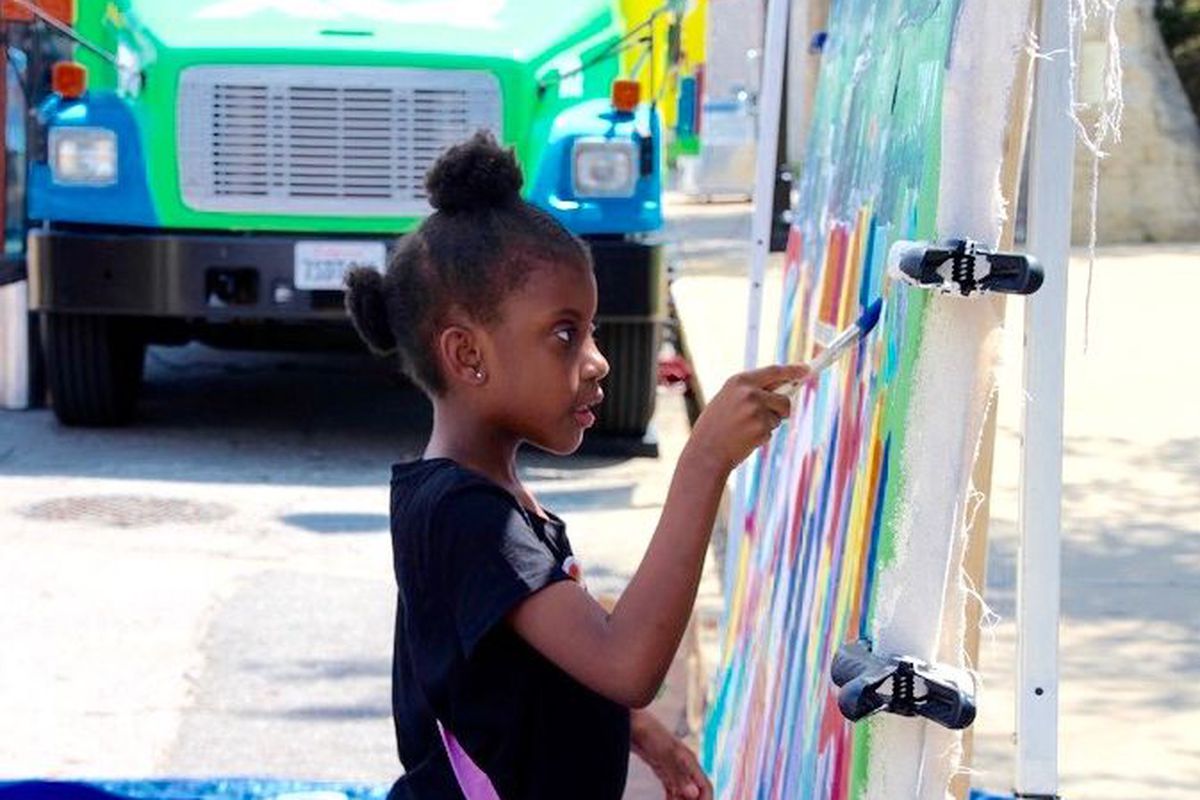 Gabrielle Colburn, 7, adds her artistic flair to a mural in downtown Memphis in conjunction with the XQ Super Schools bus tour in June. (Caroline Bauman)