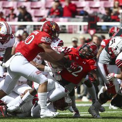 Utah Utes running back Devin Brumfield (22) is tackled while carrying the ball during the Red-White game at Rice-Eccles Stadium in Salt Lake City on Saturday, April 13, 2019.