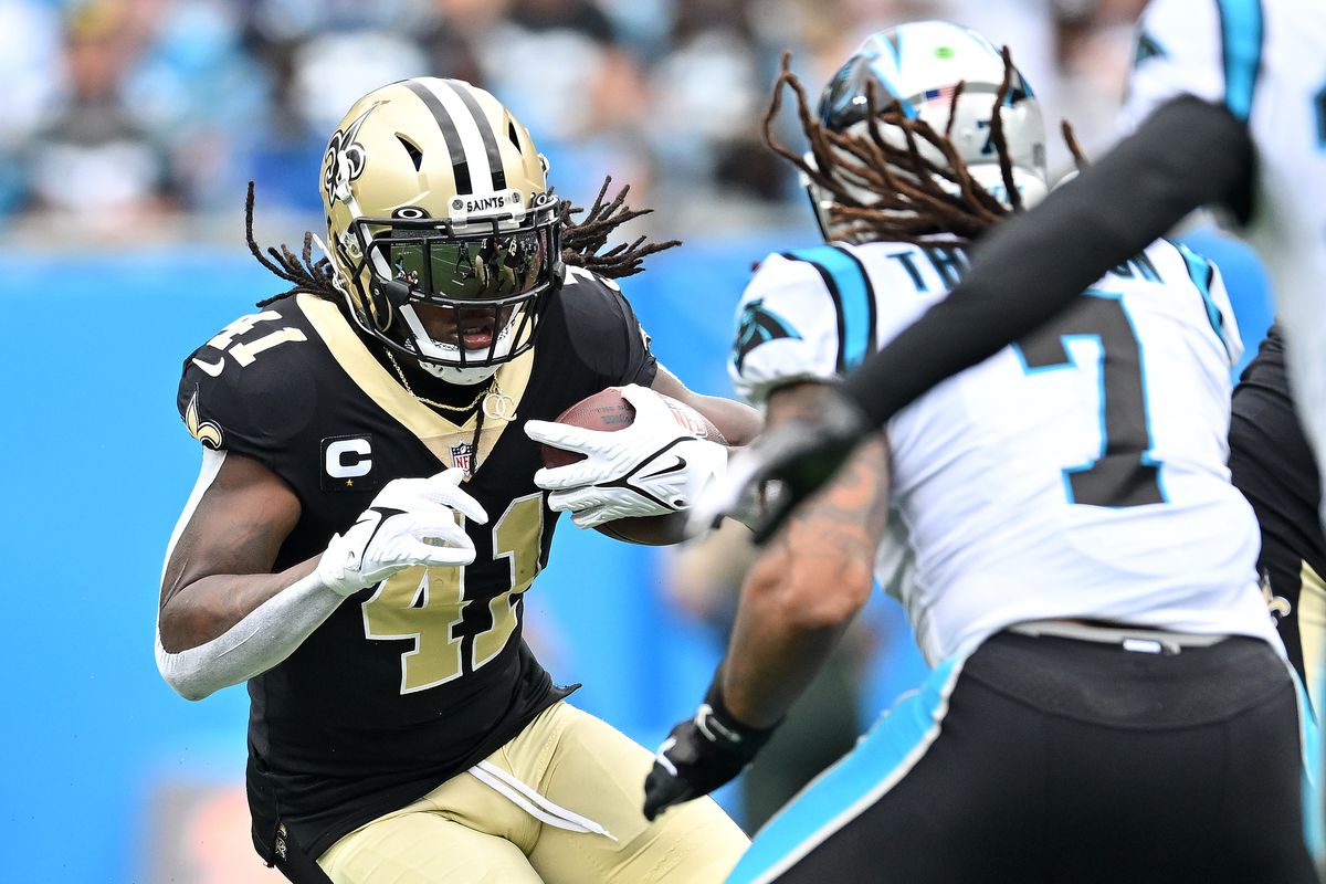 Alvin Kamara #41 of the New Orleans Saints runs with the ball against Shaq Thompson #7 of the Carolina Panthers during the first quarter at Bank of America Stadium on September 25, 2022 in Charlotte, North Carolina.