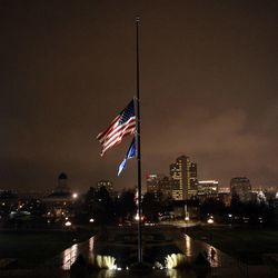 The flag is at half mast during a vigil honoring those affected by the school shooting at Sandy Hook Elementary School in Newtown, Conn., outside of the state Capitol in Salt Lake City on Friday, Dec. 14, 2012.