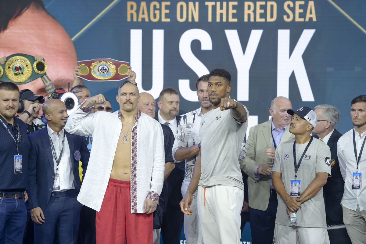 Oleksandr Usyk and Anthony Joshua pose for the cameras during the weigh-in for the Rage on the Red Sea Heavyweight Title Fight at King Abdullah Sports City Arena on August 20, 2022 in Jeddah, Saudi Arabia.