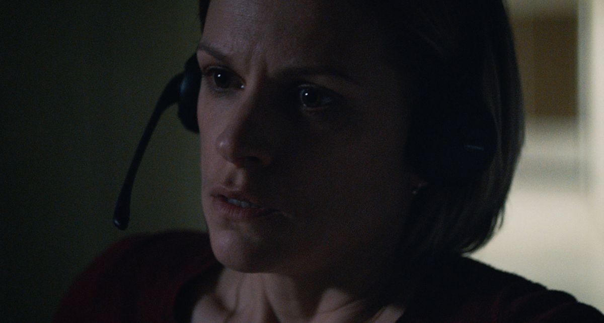 A woman wearing a headset looks shocked.