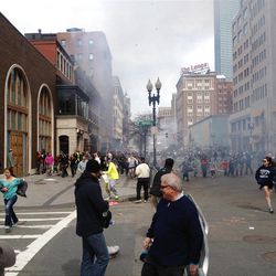 This Monday, April 15, 2013 photo shows a man who was dubbed Suspect No. 2 in the Boston Marathon bombings by law enforcement, on the left side of the frame, wearing a white baseball cap, walking away from the scene of the explosions. The FBI identified him as 19-year-old college student Dzhokhar Tsarnaev, who along with his brother Tamerlan, 26, previously known as Suspect No. 1, killed an MIT police officer, severely wounded another lawman and hurled explosives at police in a car chase and gun battle during a night of violence, early Friday, April 19, 2013. Tamerlan Tsarnaev was killed overnight, officials said, while his brother Dzhokhar remains at large. (AP Photo/David Green)  EXCLUSIVE CONTENT-SPECIAL RATES APPLY FOR NON-AP MEMBERS AND  SUBSCRIBERS.