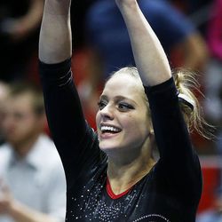 Breanna Hughes of Utah acknowledges the audience after scoring a 10 for her performance on the floor during NCAA gymnastics against Georgia in Salt Lake City, Saturday, March 12, 2016.