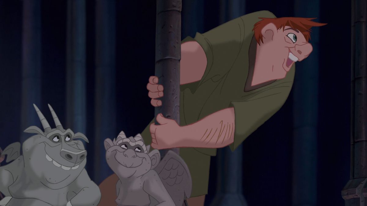 The hunchback Quasimodo clutches a stone pillar and leans outward from the cathedral of Notre Dame as he sings, while two of his animated gargoyle friends smile supportively at him in Disney’s animated feature The Hunchback of Notre Dame