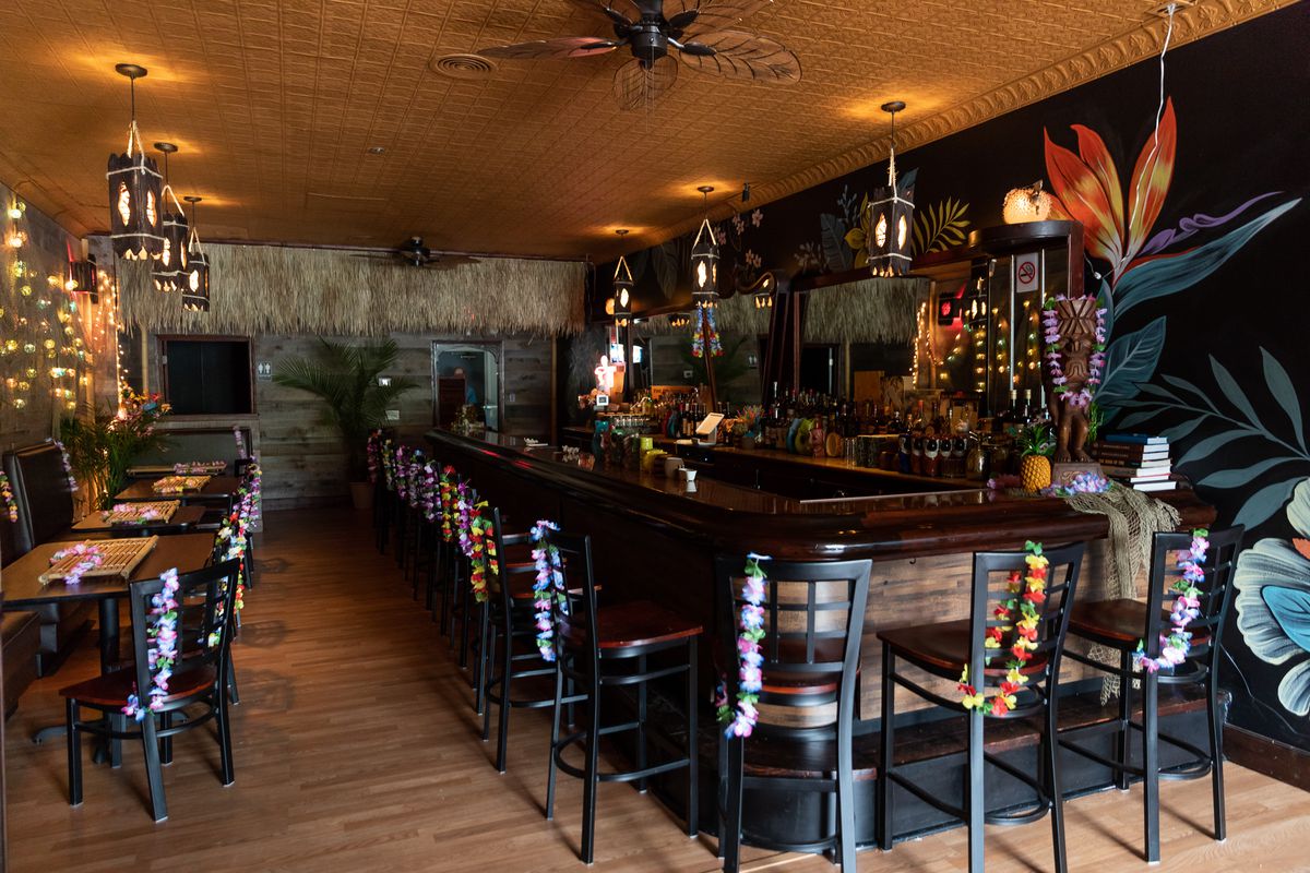 Lost River Tiki Bar’s interior including the bar and a mural of flowers